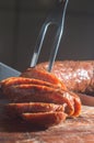 Sliced Ã¢â¬â¹Ã¢â¬â¹smoked calabrese sausage in a wooden table,copy space